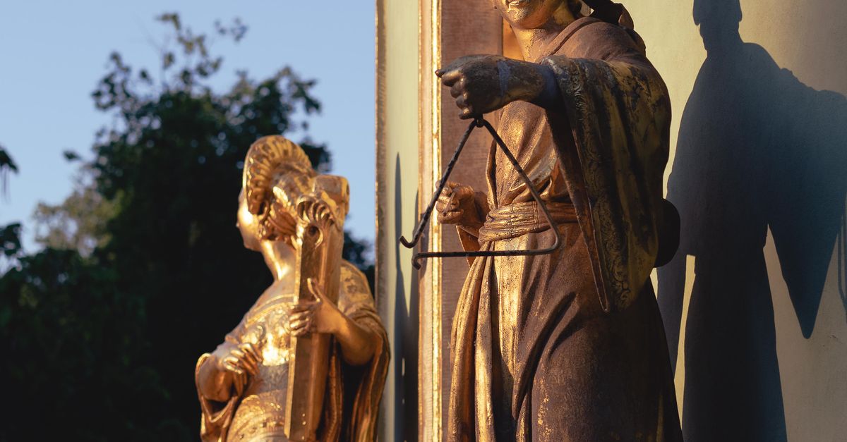 Two Gold Statues Two Golden Statues Outside a Building · Free Stock Photo