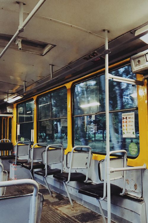 Free Explore the nostalgic interior of a vintage tram in Barnaul, Russia, showcasing empty seats and urban reflections. Stock Photo
