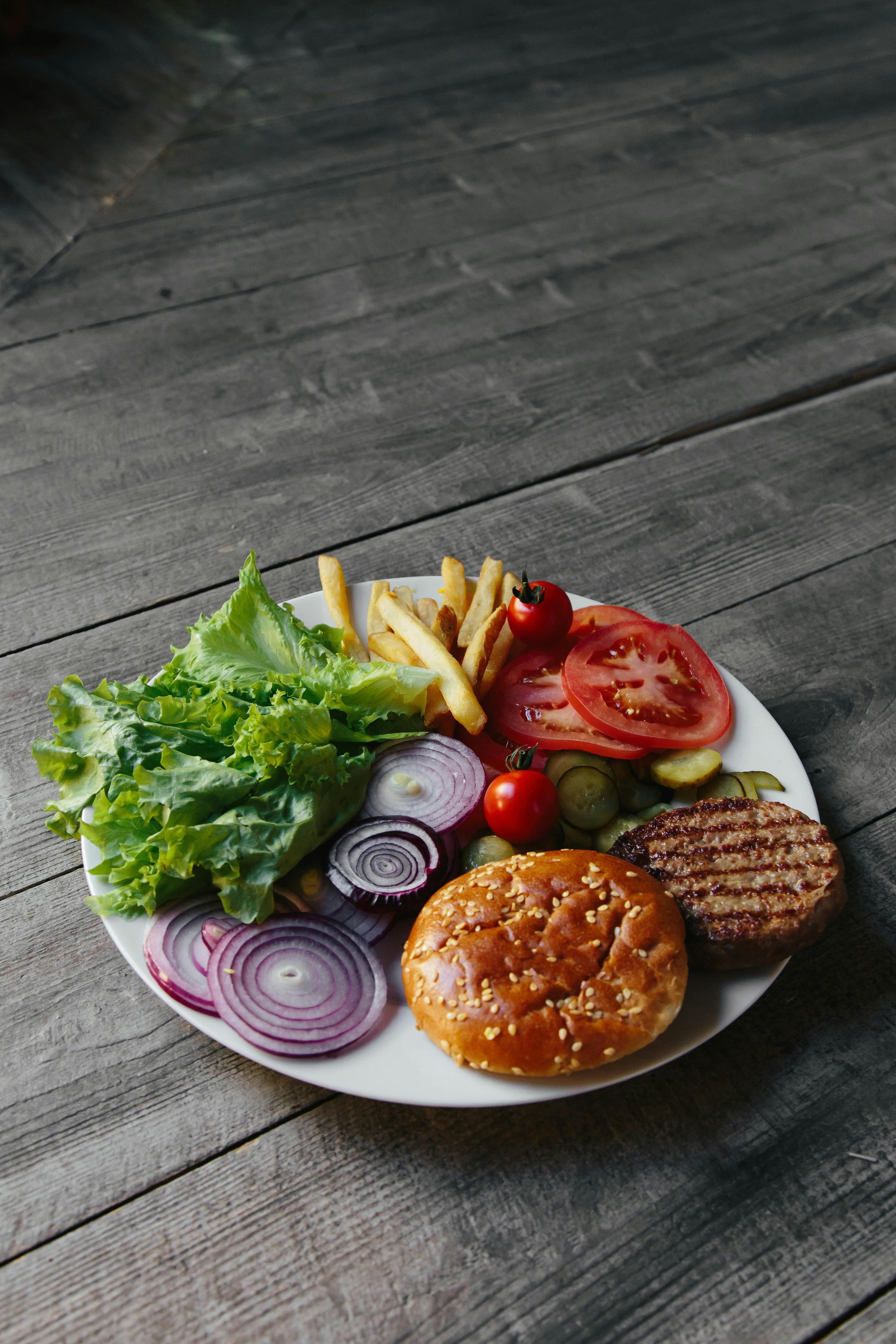 A plate of chole bhature with pickles and onions