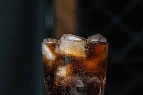 Cooling beverage with fizzy bubbles and ice cubes in a clear glass — photo by Ron Lach on Pexels