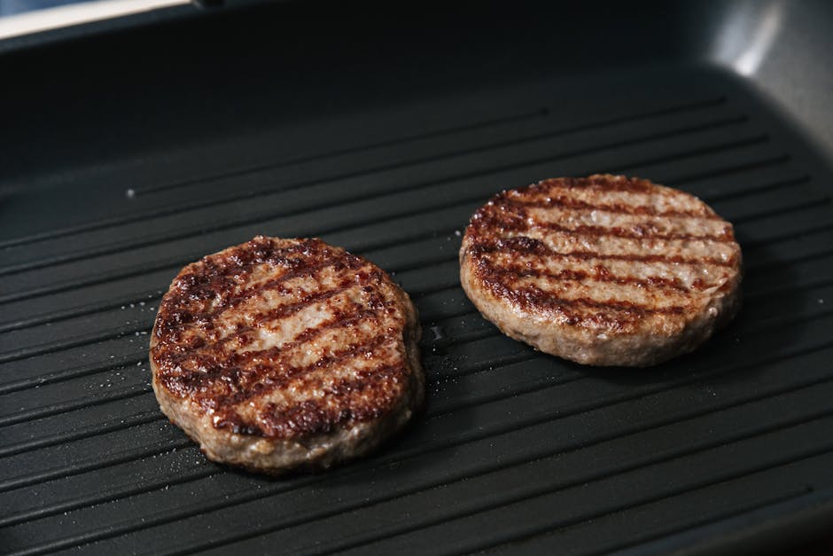 burgers sizzling on a hot griddle surface - Griddle for burgers burgers sizzling on a hot griddle surface - Griddle for burgers