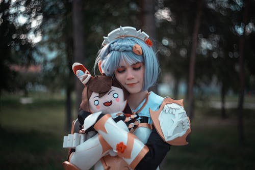 Photo of a Cosplayer Hugging a Plush Toy