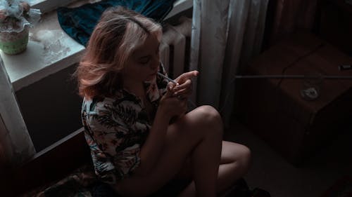 Top View Shot of a Woman Sitting while Lightning the Cigarette