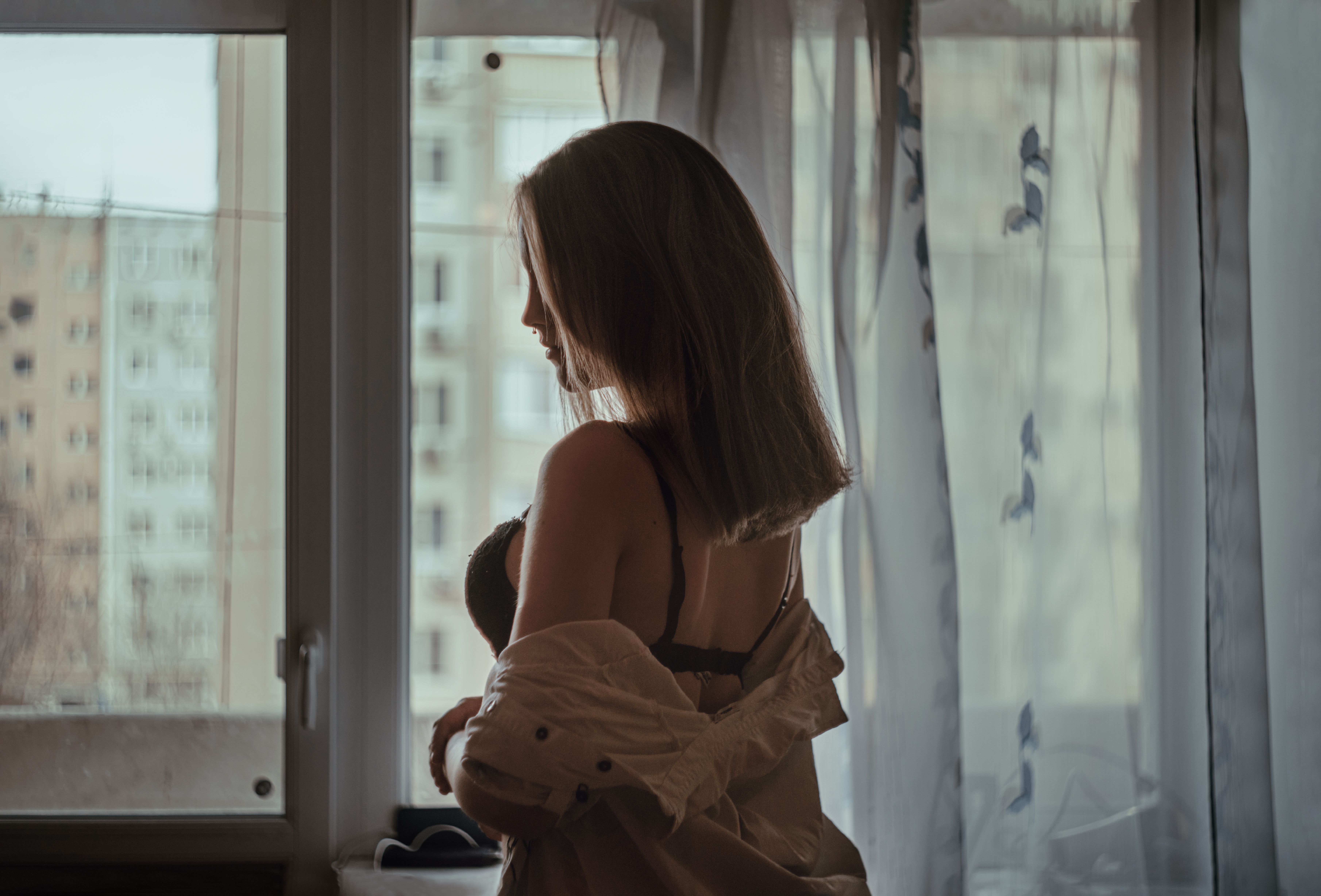A Woman Sitting Alone by the Glass Window · Free Stock Photo
