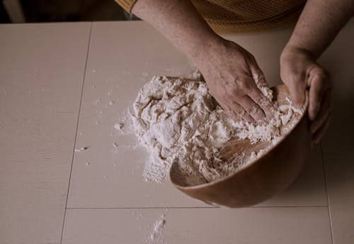 Photo of a Person's Hands Kneading Dough
