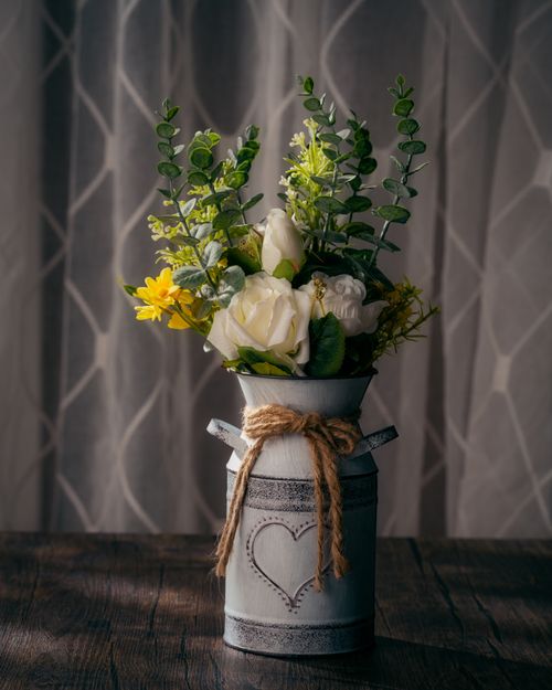 Free A rustic vase filled with a vibrant floral arrangement adding elegance to any room. Stock Photo