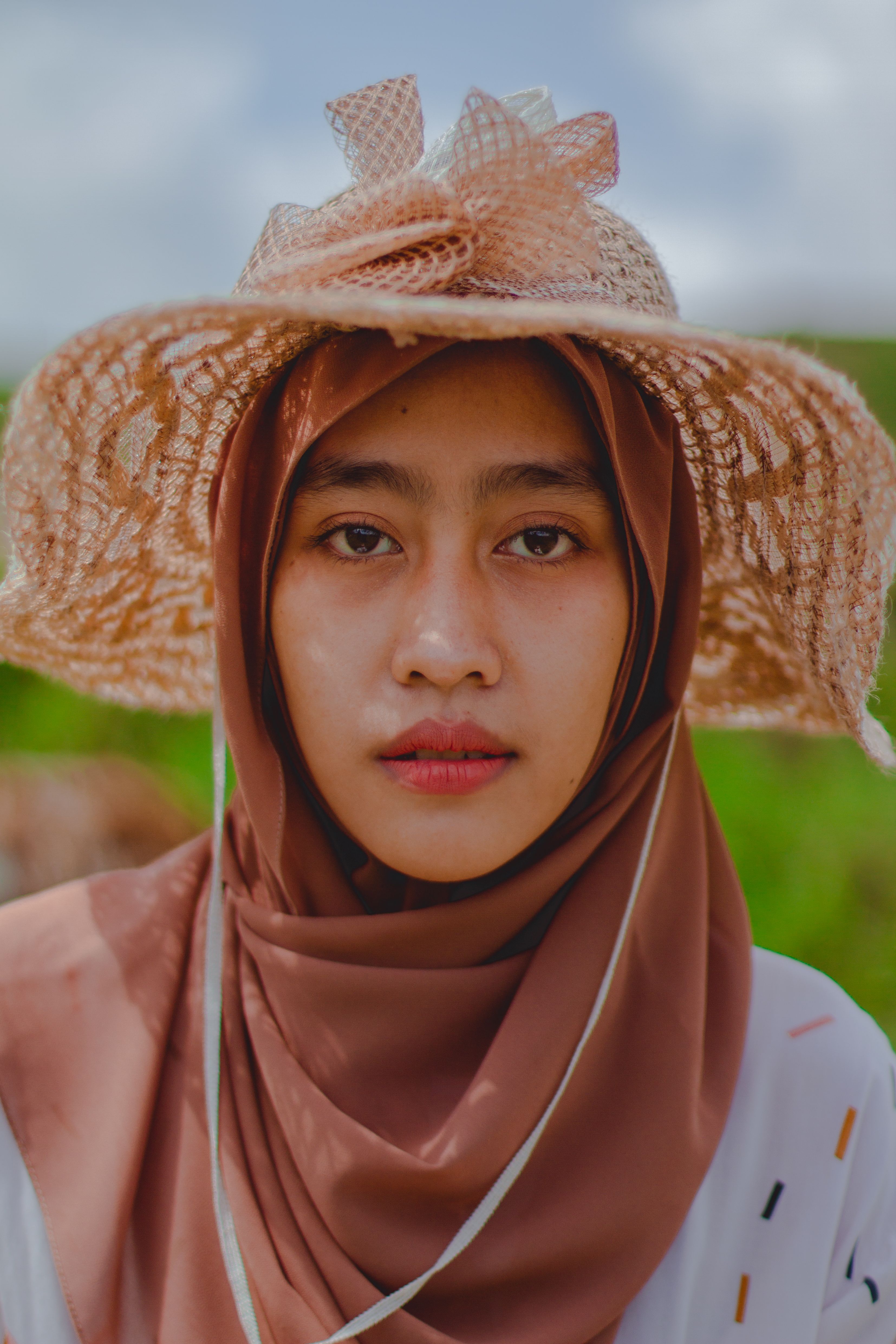 Portrait of a Girl with a Hat Posing with Her Hand on Her Chin · Free