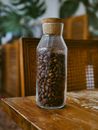 Brown and White Beans in Clear Glass Jar on Brown Wooden Table