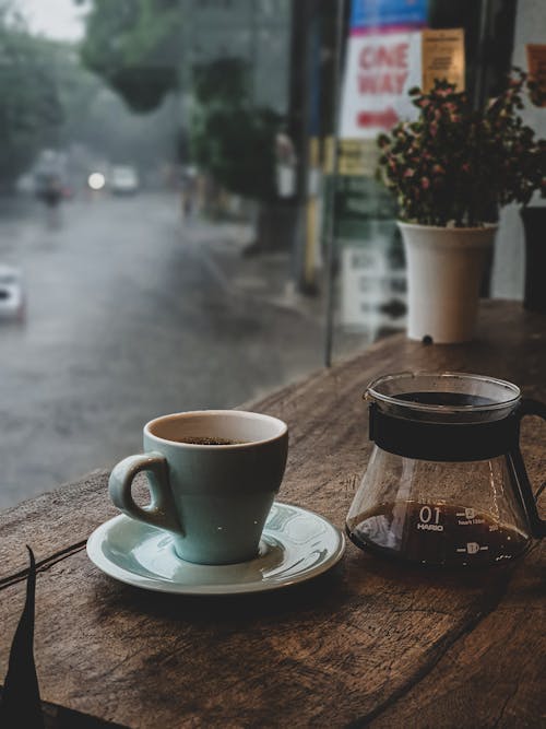Free Photo of a Cup of Coffee and a Saucer on a Wooden Surface Stock Photo