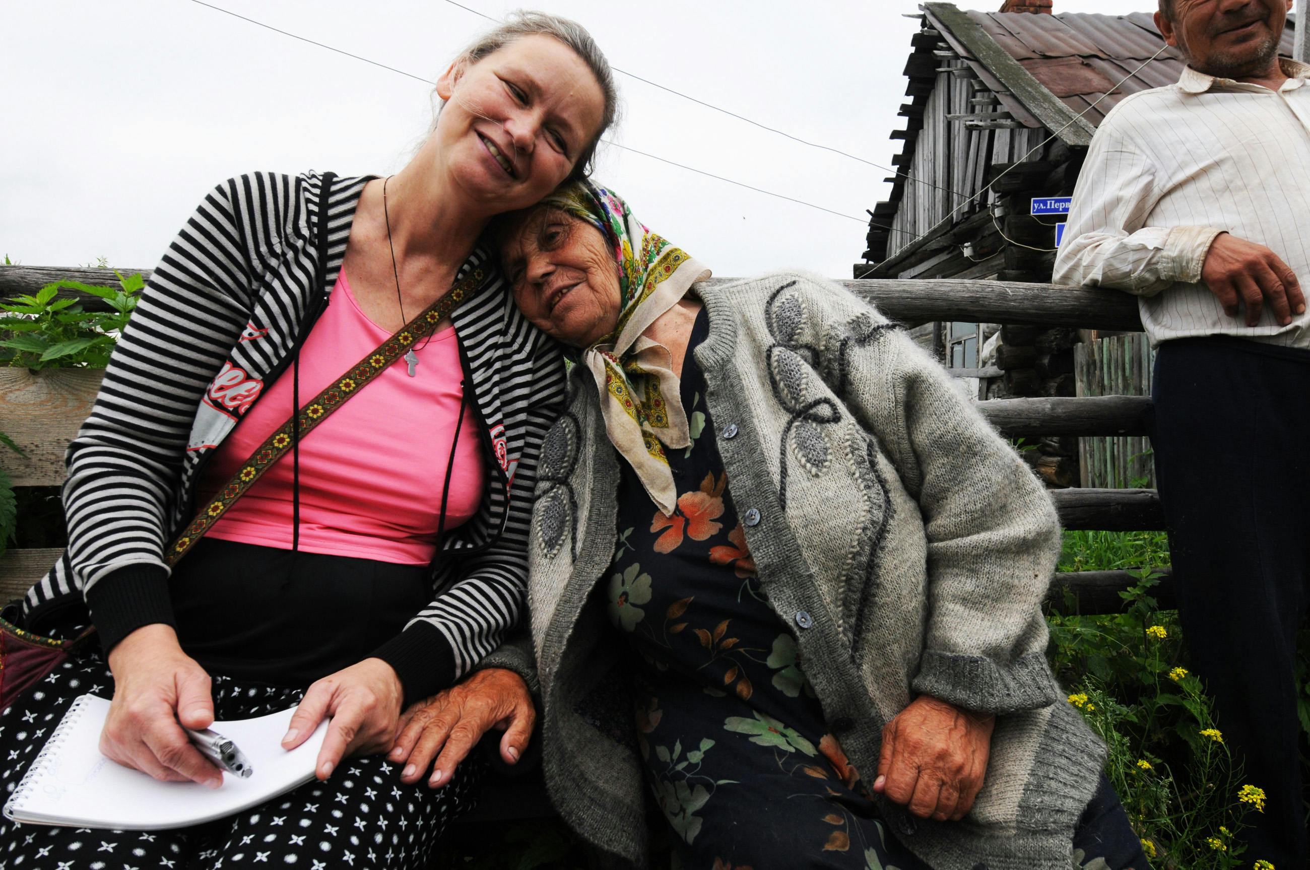 photo of an elderly woman leaning on her daughter