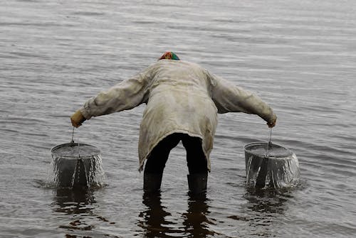 A Person Carrying Buckets of Water