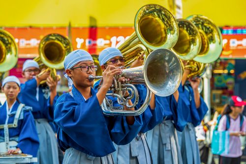 Free Colorful brass band performance at a festival parade in Taiwan, featuring musicians in traditional attire. Stock Photo