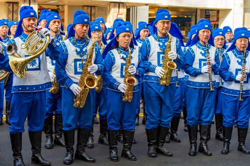Free A vibrant marching band performing in Taiwan, showcasing blue uniforms and brass instruments in an outdoor parade. Stock Photo
