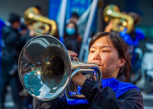 Free Close-up of an Asian woman performing with a trumpet during a vibrant street parade in Taiwan. Stock Photo
