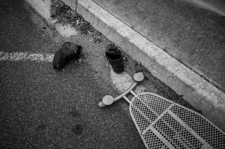 Black Leather Boots On Street Gutter