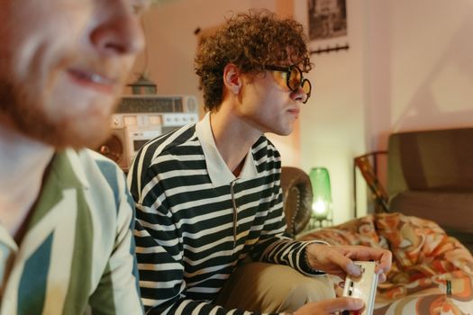 Two young men enjoying video games in a retro-themed room, capturing a nostalgic and fun atmosphere.