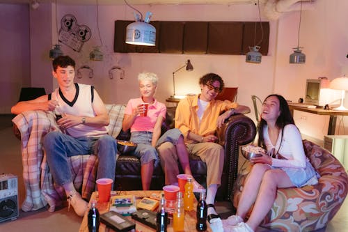 Free Group of Friends Sitting on the Living Room Stock Photo