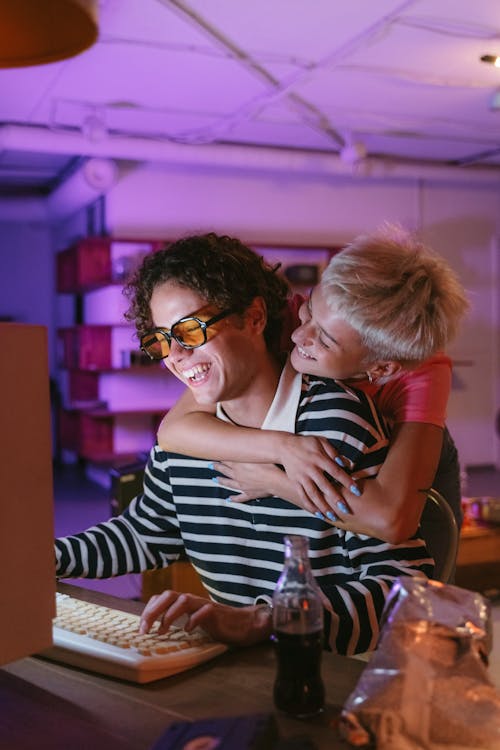 Woman Hugging Man While Using a Computer · Free Stock Photo