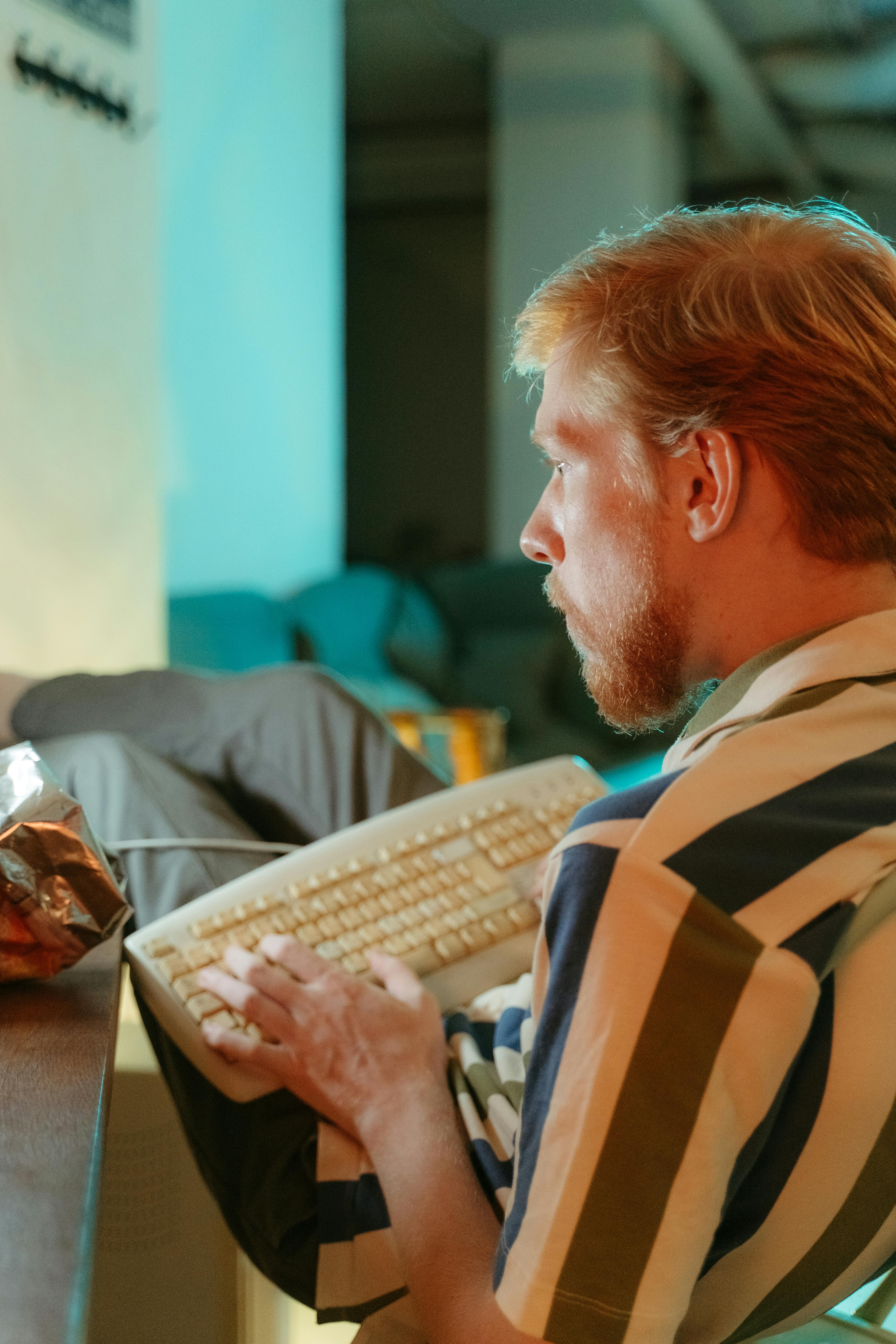 a computer keyboard on a man s lap