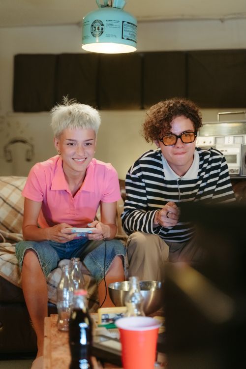 Free Happy couple playing video games together on a cozy night in. Stock Photo