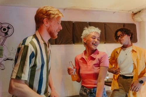 Free Group of young friends dancing and having fun at a casual indoor home party. Stock Photo