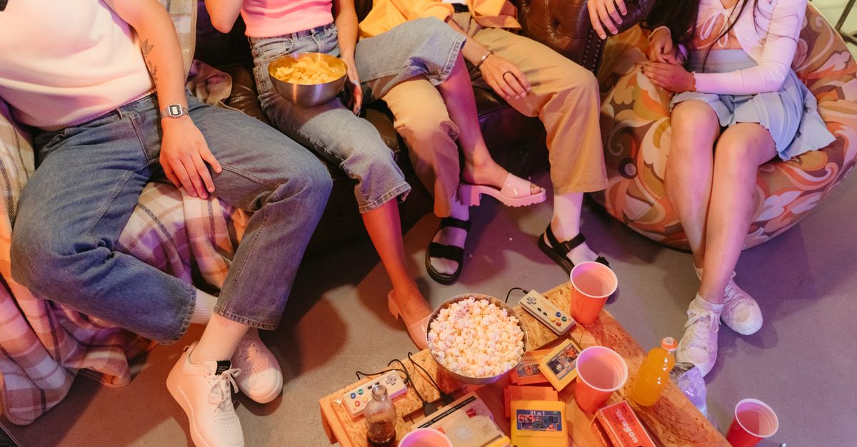 friends debating streaming choices on couch with popcorn