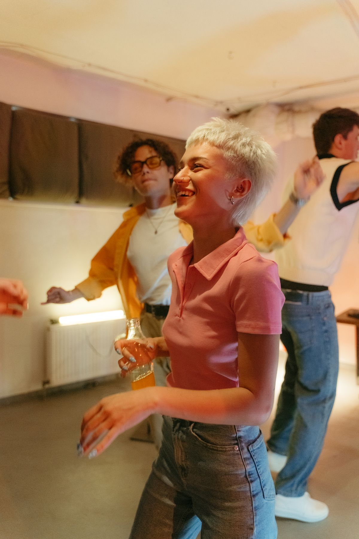A lively group of friends dancing together at an indoor house party