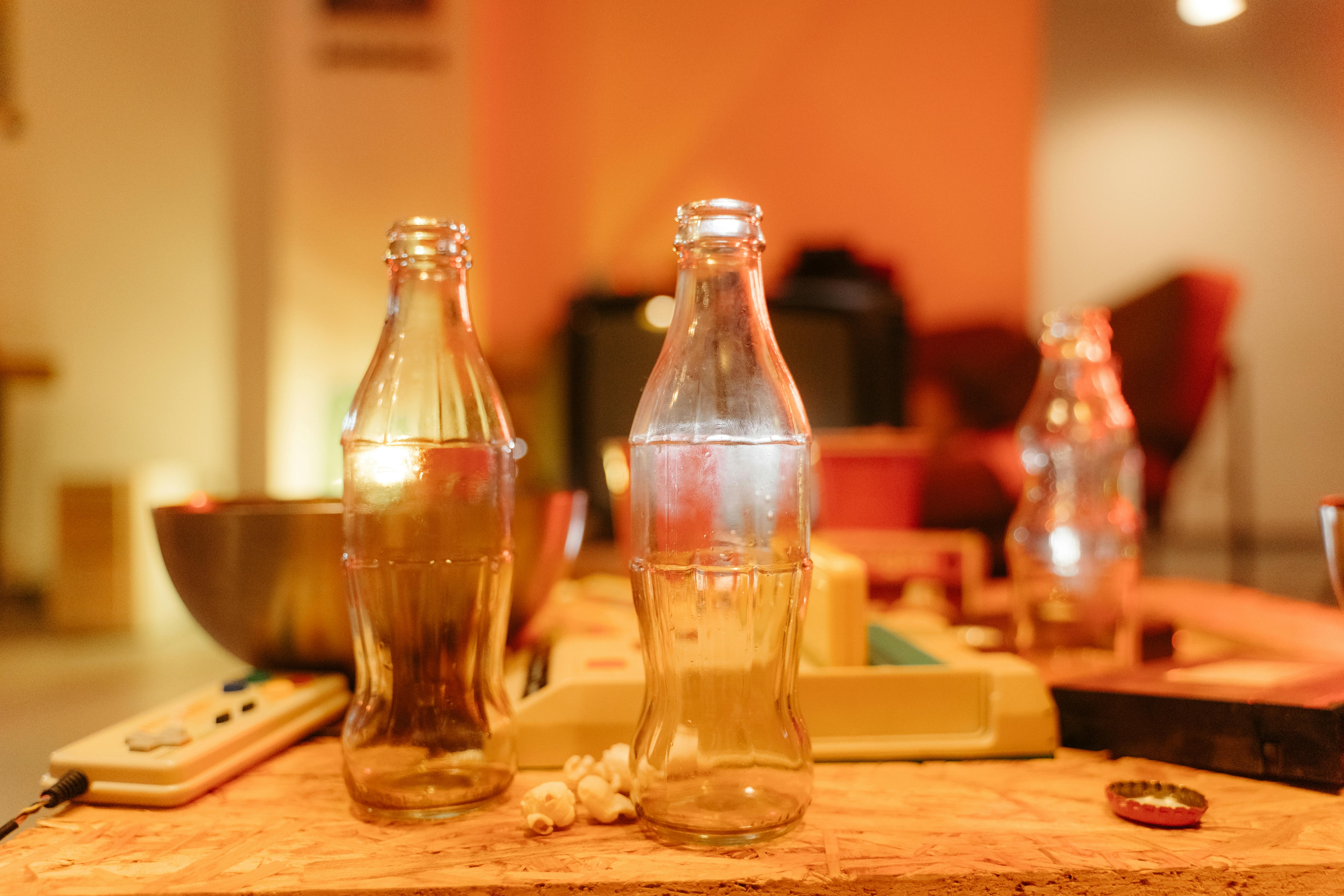 clear glass bottles on brown wooden table