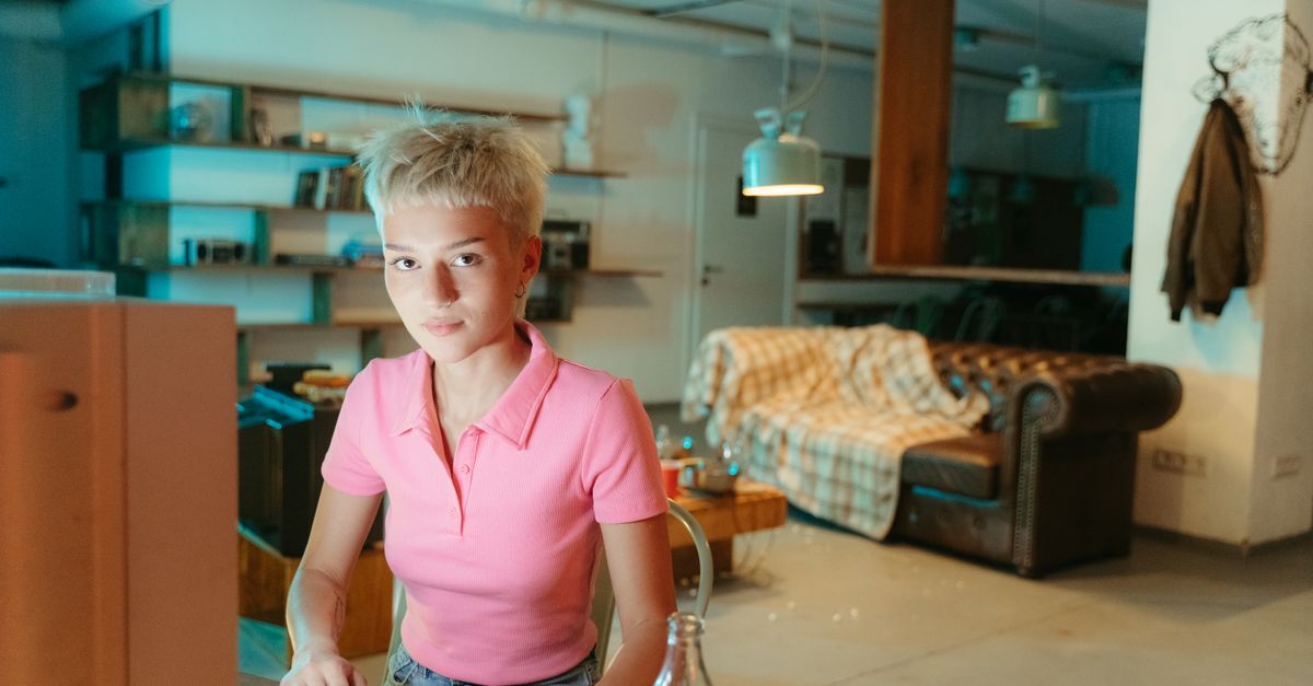 Teenager in a retro setting using an old computer with a soft drink on the desk.