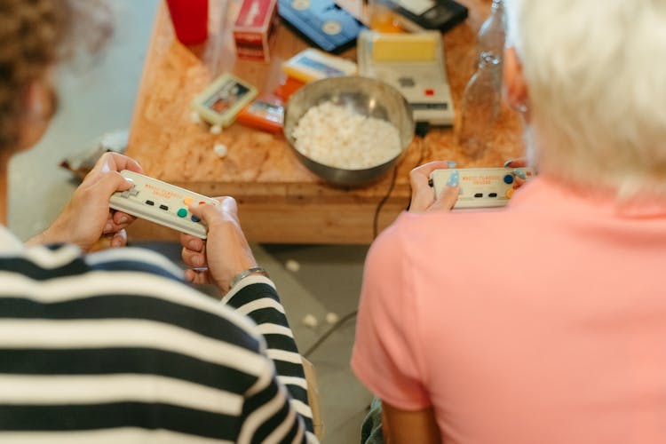 Friends Holding Video Game Controllers