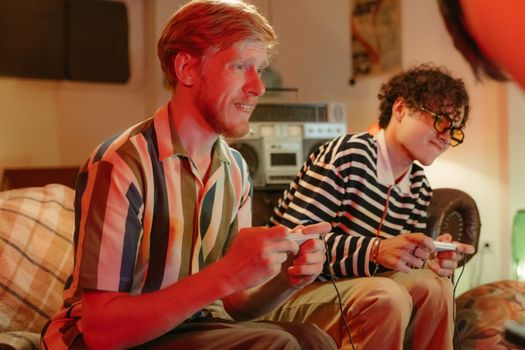 Two young adults enjoying a video game in a cozy living room setting, capturing friendship and leisure time.