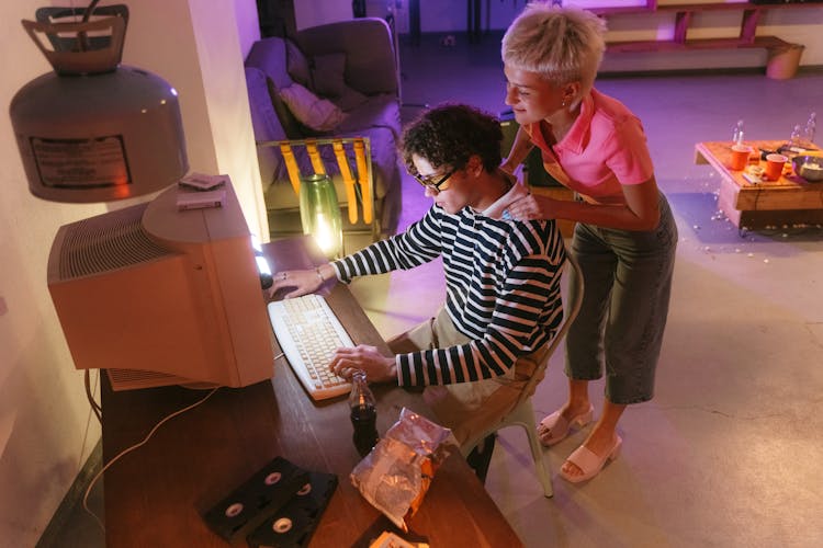 Man On A Computer Beside A Woman