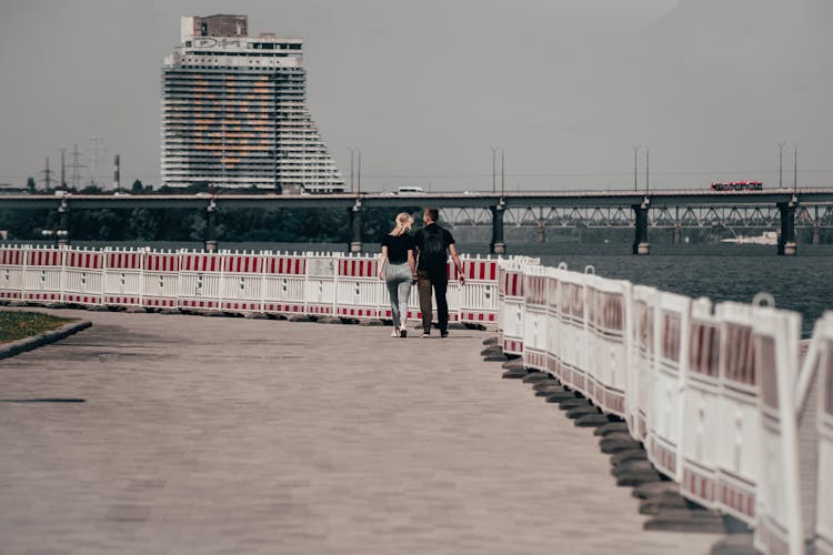 Couple Walking Beside A River