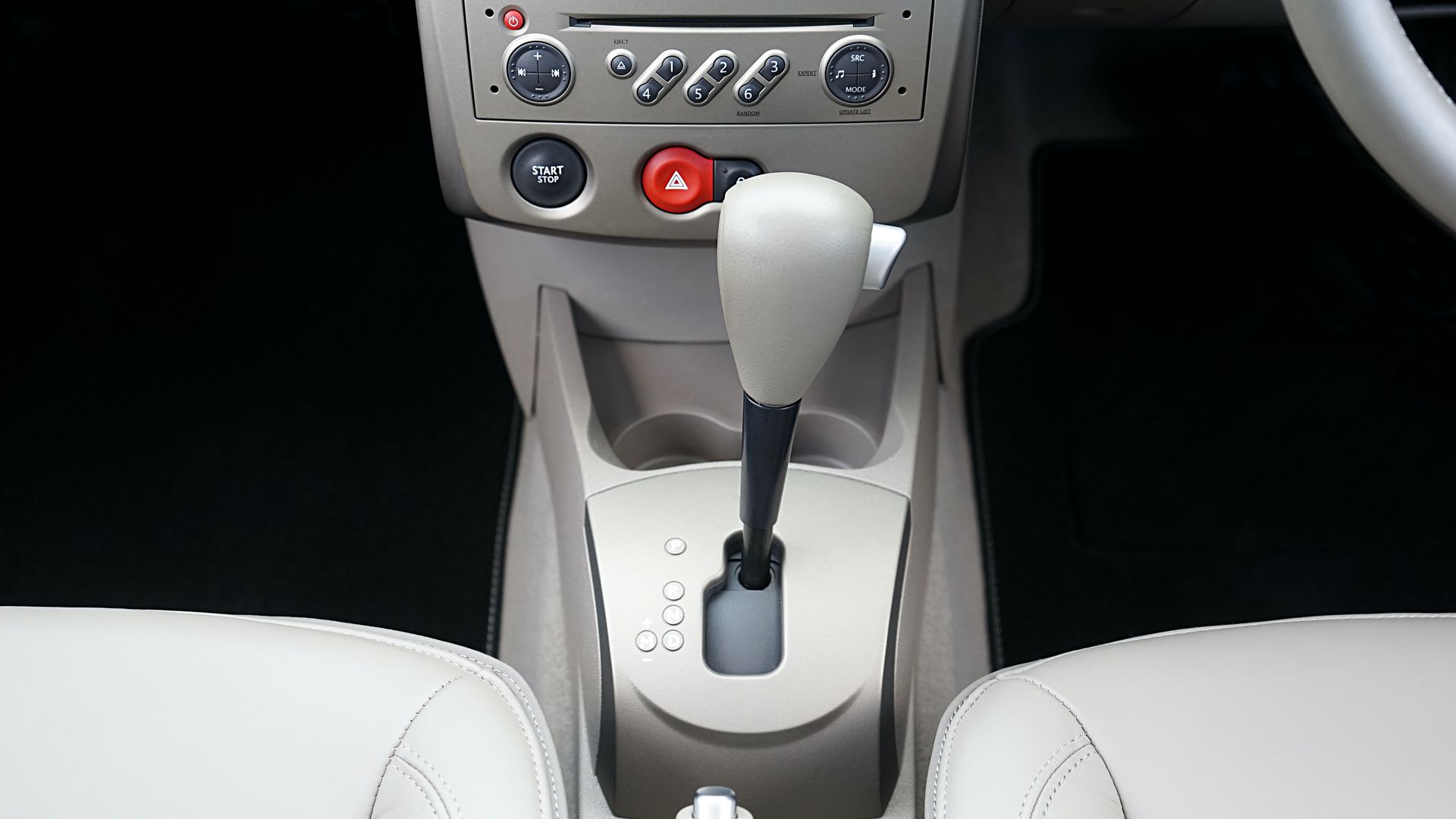 Close-up view of a car's center console featuring a gear shift and control buttons.