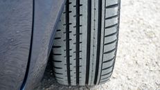 Black Car Tire on Gray Concrete Floor