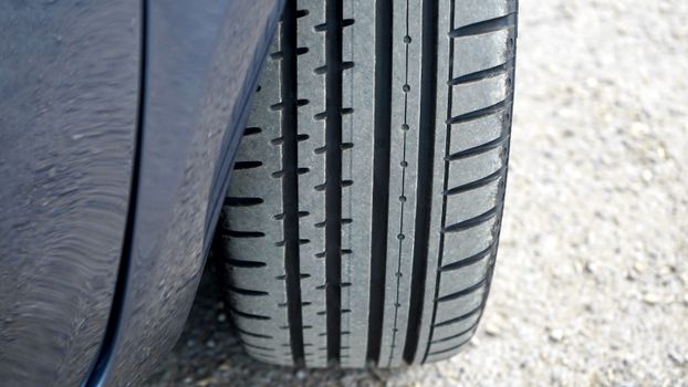 Black Car Tire on Gray Concrete Floor