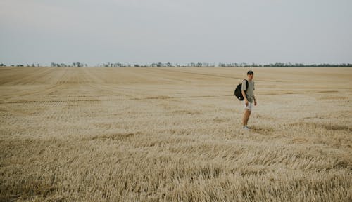 Photo of a Man Standing in a Field