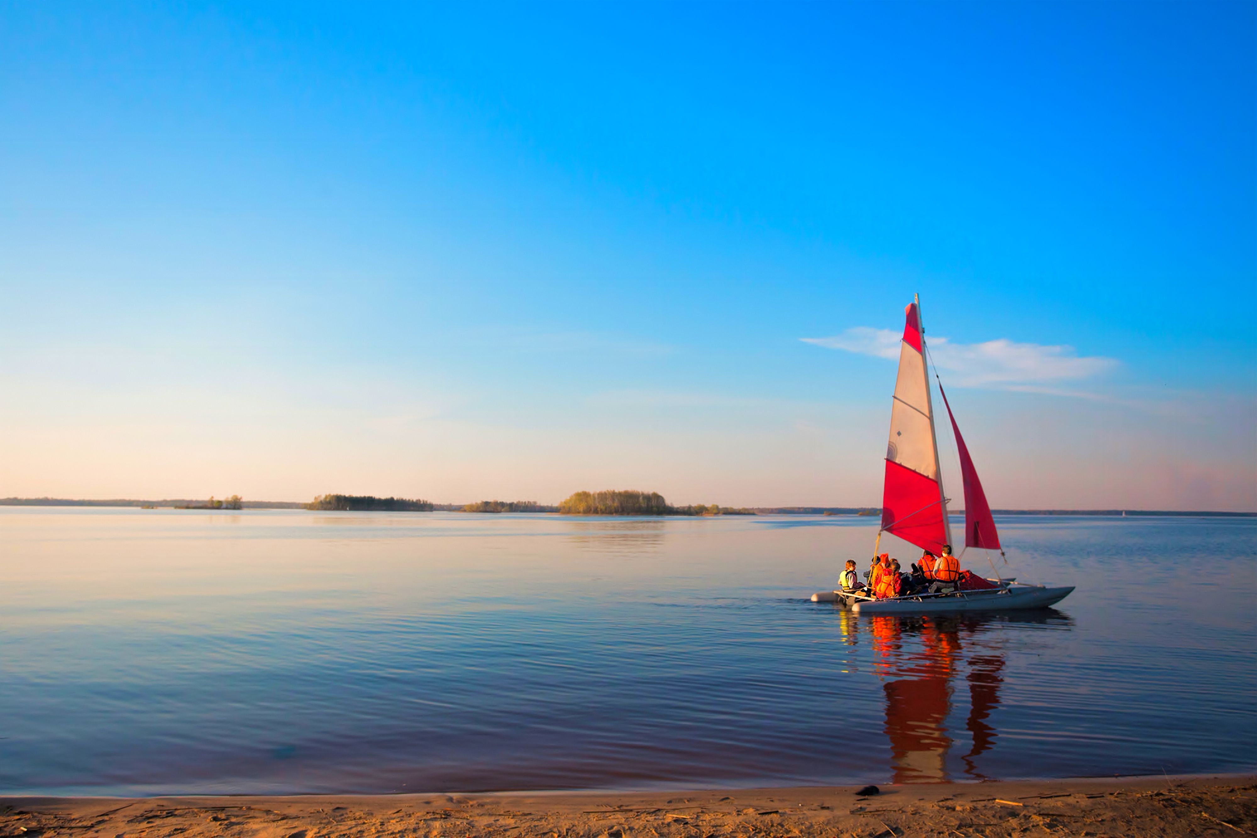 People Riding a Sailboat in the River Under Blue Sky · Free Stock Photo