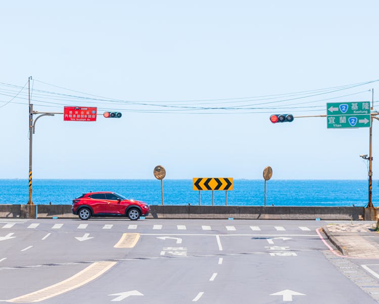 A Red Car Passing The Road