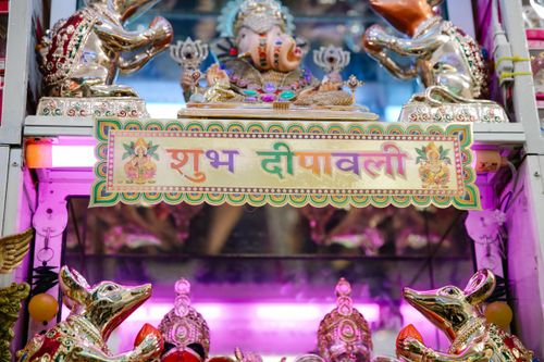 Free Colorful display of Diwali decorations featuring a Ganesh statue, vibrant lighting, and traditional Hindu elements. Stock Photo