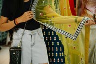 Photo of a Woman Holding a Yellow Fabric
