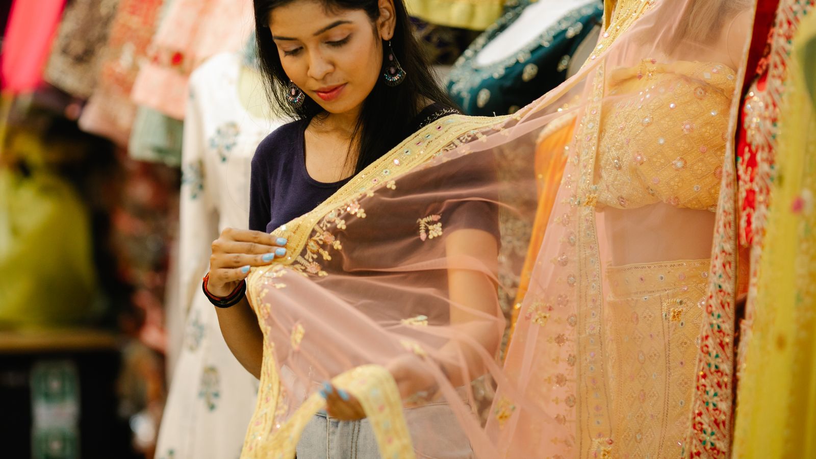Woman examining saree fabric