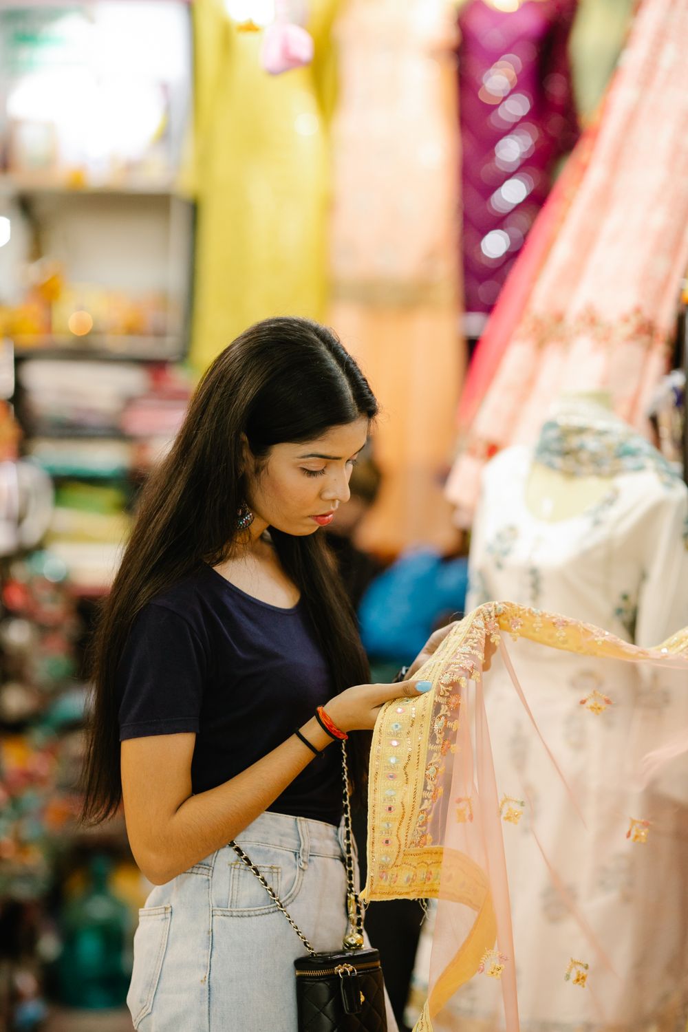 Customer choosing Indian fabric in a clothing shop