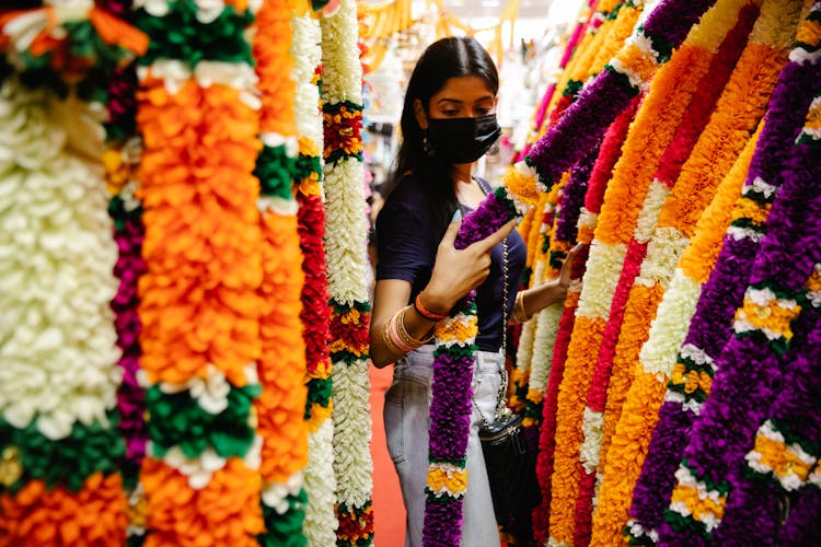 A Woman Touching A Fabric In A Store