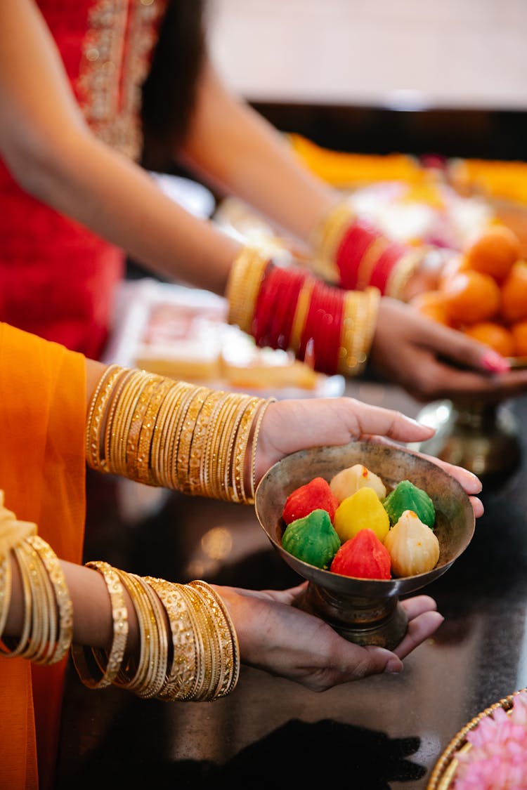 Unrecognizable Women Presenting Sweet Colourful Snacks 