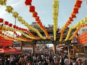 在传统寺庙里，人群欣赏着灯节丰富多彩的装饰和充满活力的文化元素