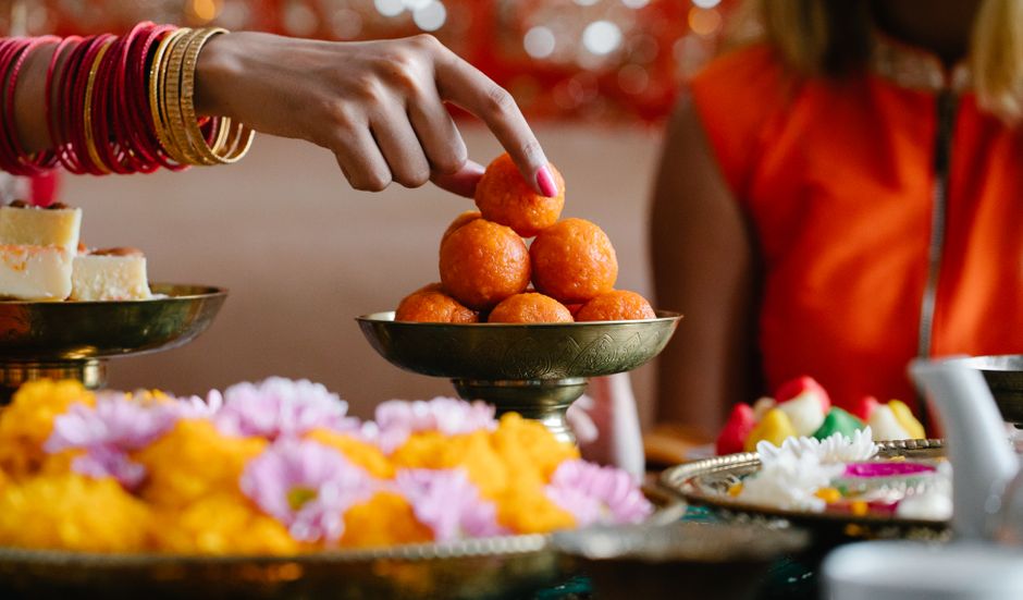 Traditional Indian sweet stall and modern dessert station comparison for wedding celebrations