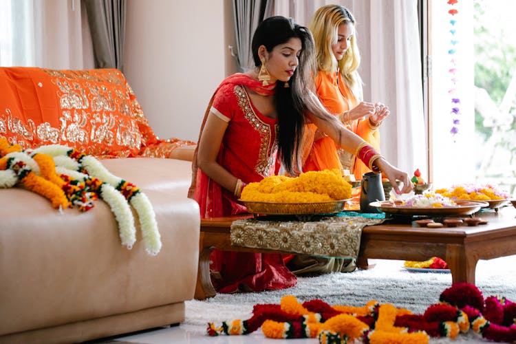 Women In Traditional Clothes Decorating House For Ceremony