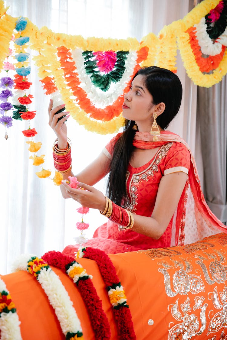 Woman In Traditional Dress Decorating House