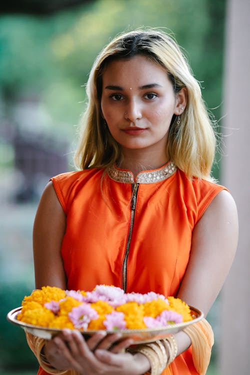 Young Woman Presenting a Platter of Food.